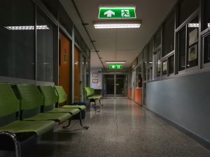 Green Emergency Exit Sign In Hospital Showing The Way To Escape