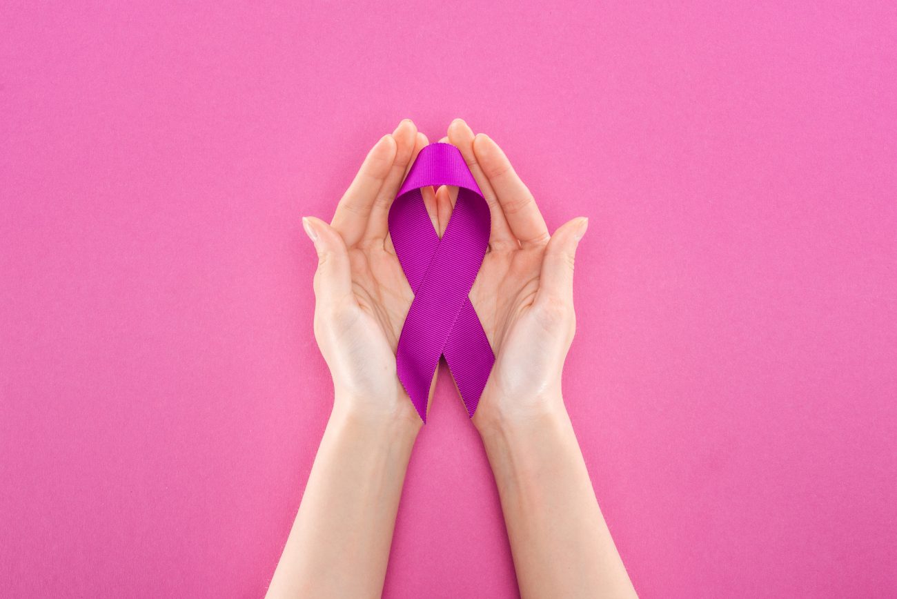 Cropped View Of Woman Holding Purple Ribbon Means Violence Isolated On Pink