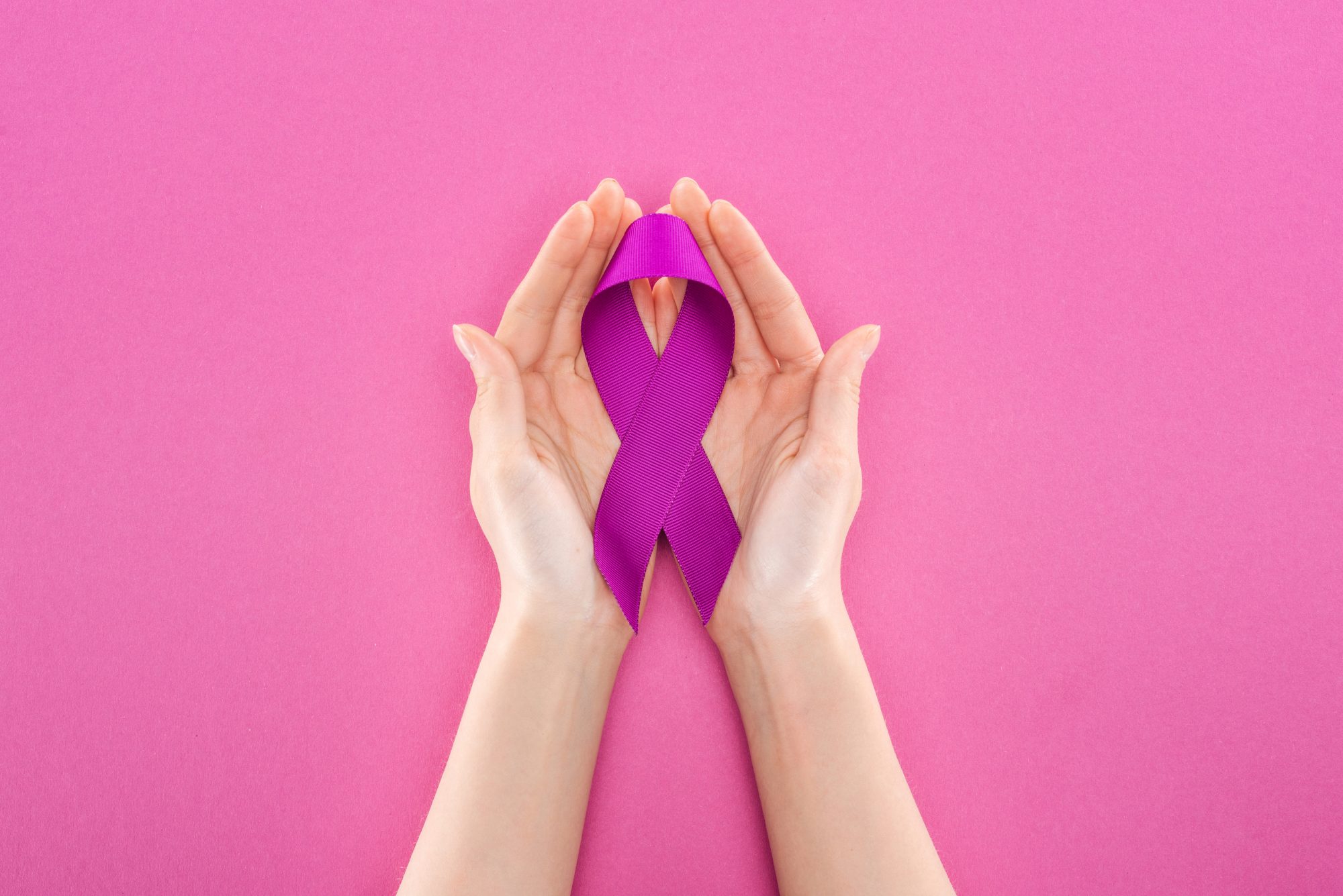 Cropped View Of Woman Holding Purple Ribbon Means Violence Isolated On Pink