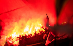 Football Hooligans With Mask Holding Torches In Fire