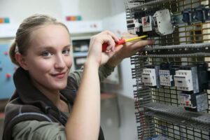 Young Woman In Professional Training Setting Up Electrical Circuit