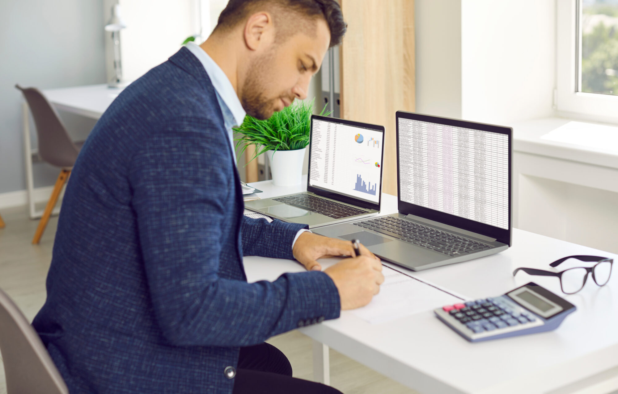 Man In Office Counting Financial Data.