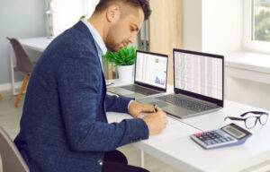 Man In Office Counting Financial Data.