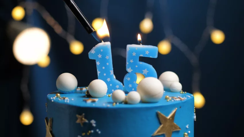 Birthday Cake Number 15 Stars Sky And Moon Concept, Blue Candle Is Fire By Lighter. Copy Space On Right Side Of Screen. Close Up