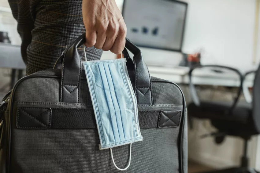 Man With A Briefcase And A Surgical Mask