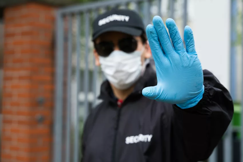 Security Guard In Face Mask Making Stop Hand Gesture