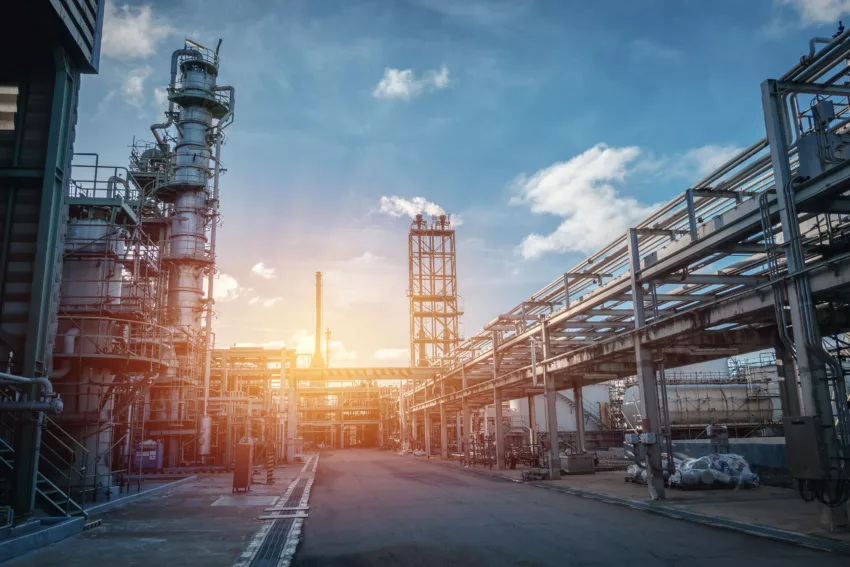 Pipeline And Pipe Rack Of Petroleum Industrial Plant With Sunset Sky Background